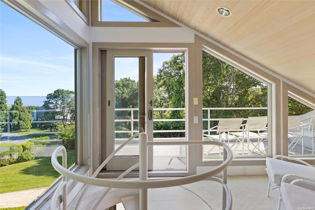 sunroom with wooden ceiling, lofted ceiling, and a water view