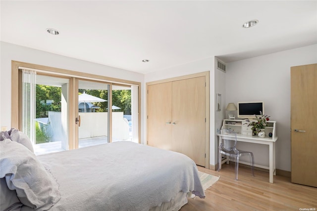 bedroom featuring access to exterior, light hardwood / wood-style flooring, and a closet