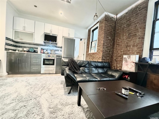 interior space featuring a wealth of natural light, crown molding, and brick wall