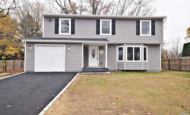 view of front property featuring a front yard and a garage