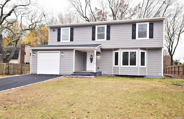 view of front property featuring a front lawn and a garage