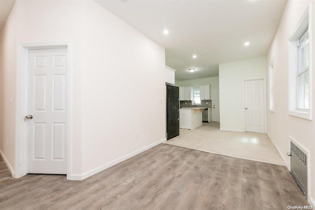 interior space with radiator heating unit and light hardwood / wood-style flooring