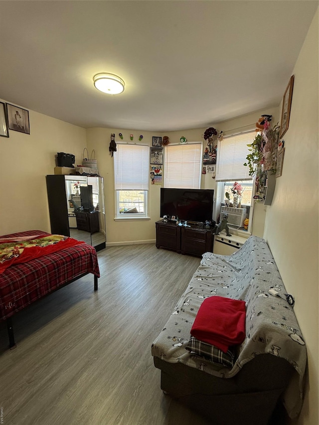 bedroom featuring wood finished floors and baseboards