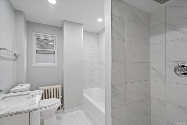 bathroom with radiator, vanity, and toilet