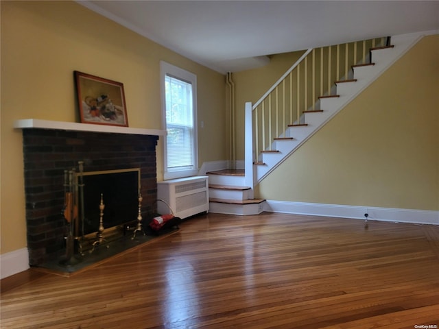 unfurnished living room with a fireplace and hardwood / wood-style floors