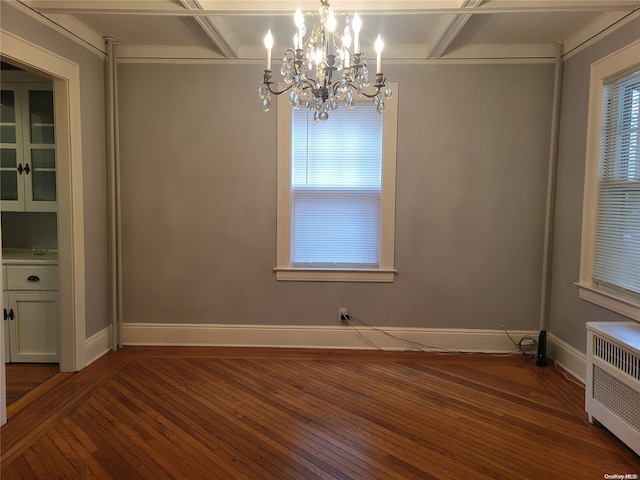 interior space with radiator, dark hardwood / wood-style flooring, coffered ceiling, and a notable chandelier