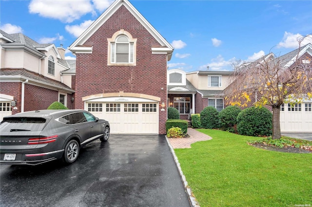 view of front of house with a garage and a front yard