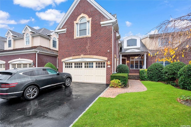 view of front of house with a garage and a front yard