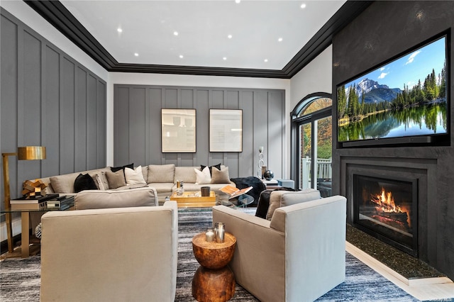 home theater room featuring dark hardwood / wood-style floors and ornamental molding