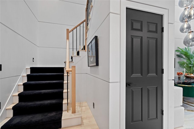 stairway with hardwood / wood-style floors