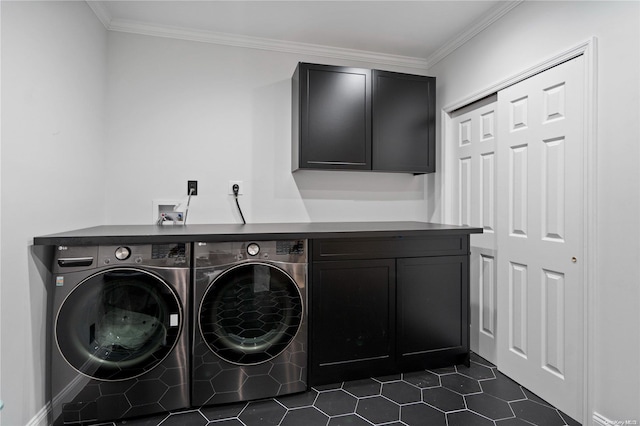 clothes washing area featuring washing machine and dryer, cabinets, dark tile patterned flooring, and ornamental molding