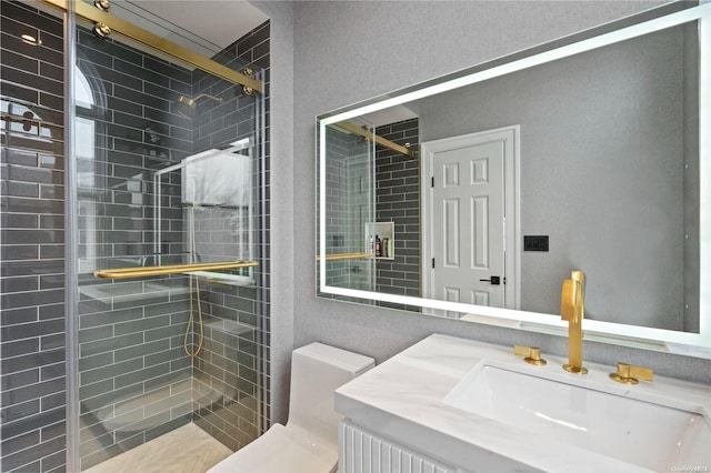 bathroom featuring vanity, toilet, and a shower with shower door