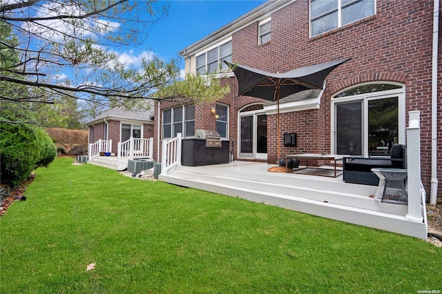 rear view of property with a lawn and central AC unit