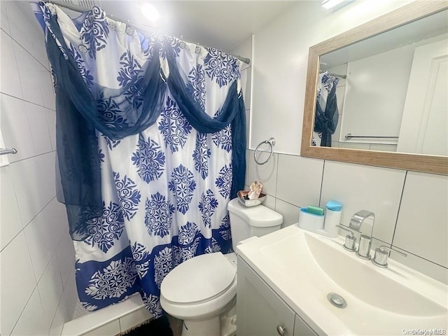 bathroom featuring vanity, toilet, tile walls, tasteful backsplash, and curtained shower