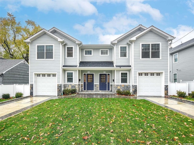 view of front of home with covered porch, a front yard, and a garage