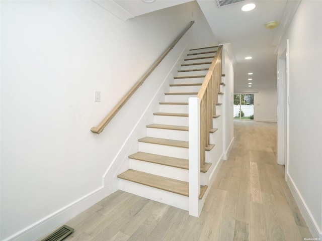 stairs with wood-type flooring