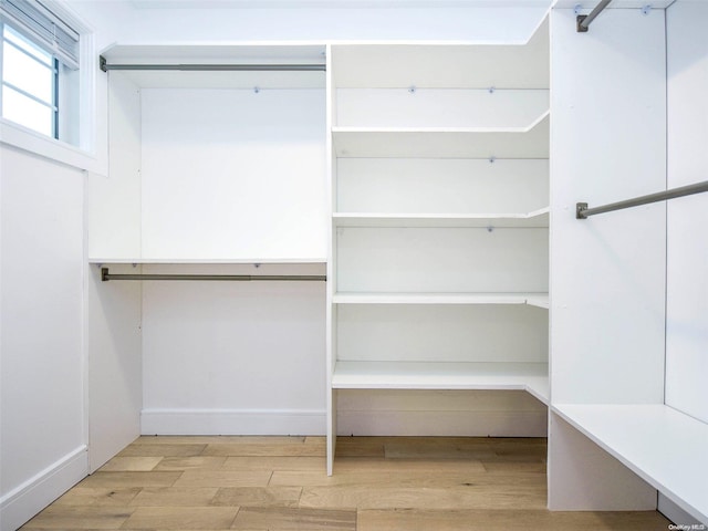 spacious closet with light hardwood / wood-style floors