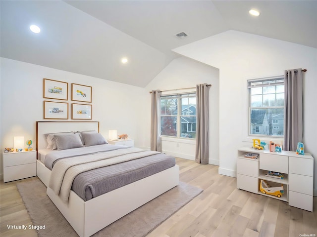 bedroom with light wood-type flooring and lofted ceiling