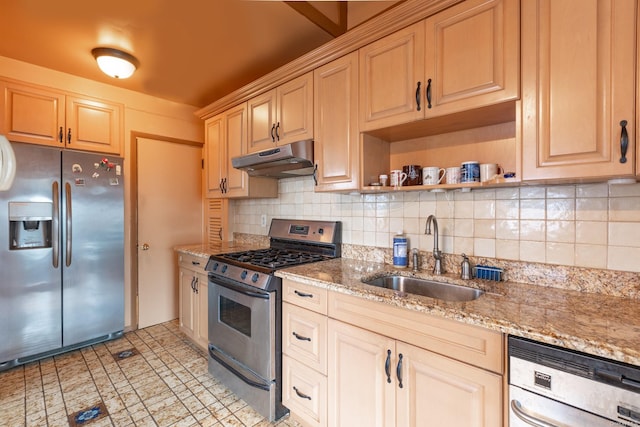 kitchen featuring decorative backsplash, appliances with stainless steel finishes, light stone counters, and sink