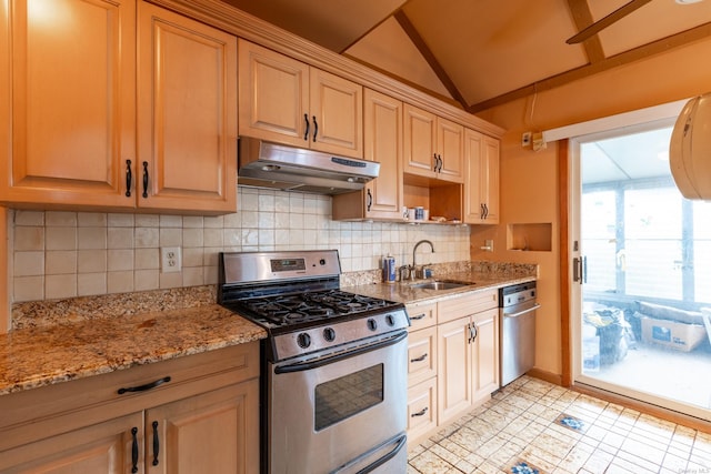 kitchen with light stone countertops, decorative backsplash, stainless steel appliances, vaulted ceiling, and sink