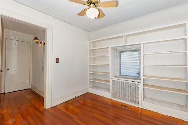 spare room featuring radiator, ceiling fan, and dark hardwood / wood-style flooring