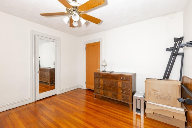 sitting room with ceiling fan and hardwood / wood-style floors