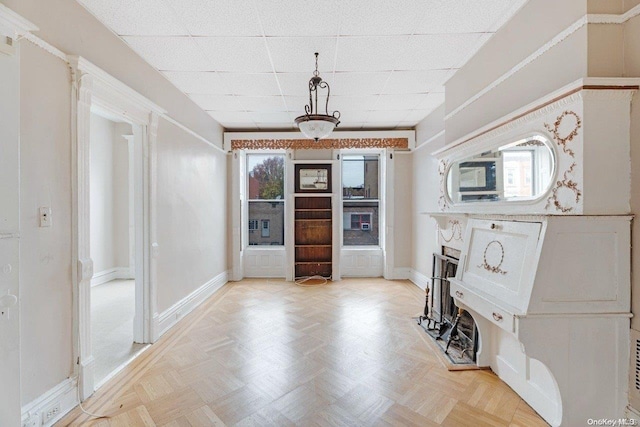 entryway featuring a drop ceiling and light parquet floors