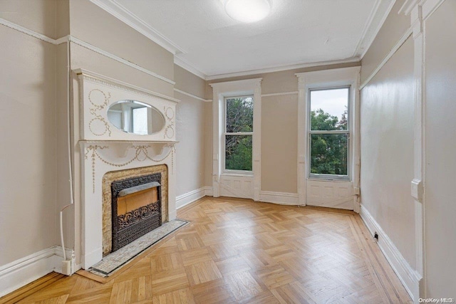 unfurnished living room featuring a fireplace, light parquet floors, and ornamental molding