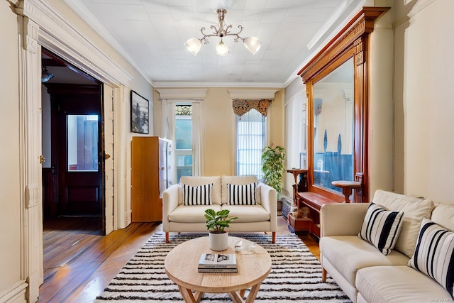 interior space with hardwood / wood-style flooring, crown molding, and a chandelier