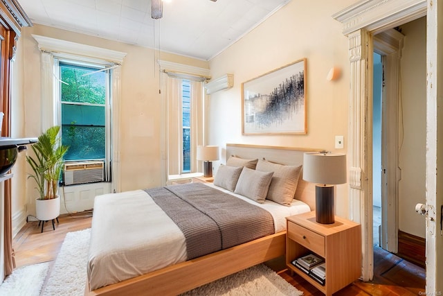 bedroom with parquet floors, ornamental molding, ceiling fan, and cooling unit