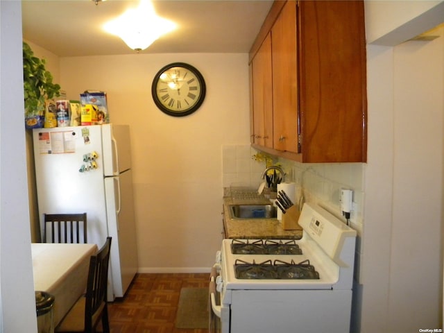 kitchen with dark parquet floors, sink, white appliances, and backsplash