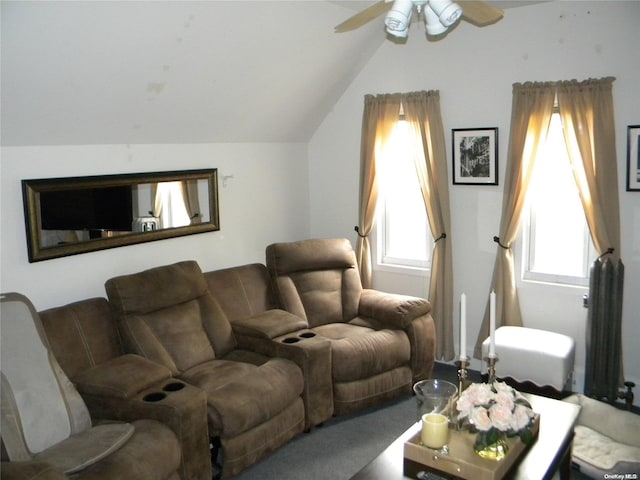 carpeted living room with vaulted ceiling, plenty of natural light, and ceiling fan