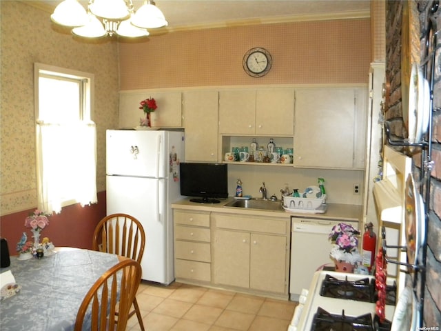 kitchen featuring white appliances, sink, ornamental molding, decorative light fixtures, and a chandelier