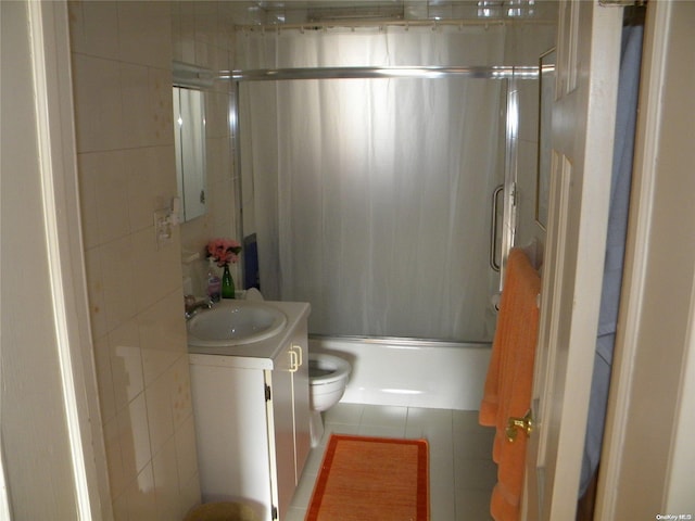 full bathroom with vanity, toilet, and shower / bath combination with glass door