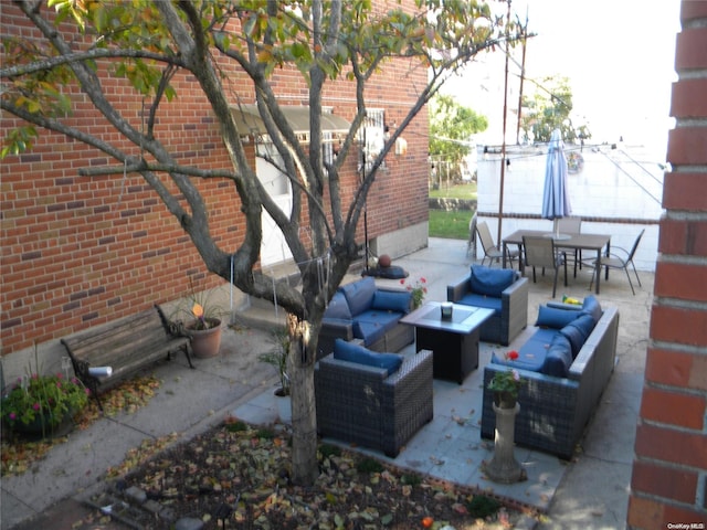 view of patio / terrace with an outdoor living space with a fire pit