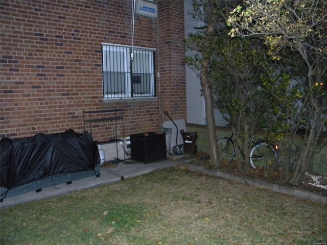 view of side of property with a lawn