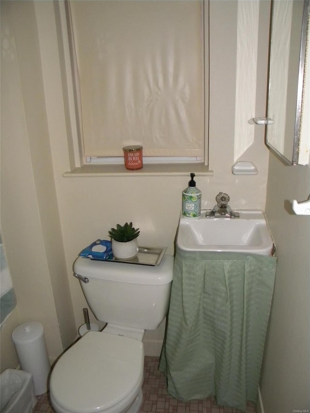 bathroom with tile patterned flooring, toilet, and sink