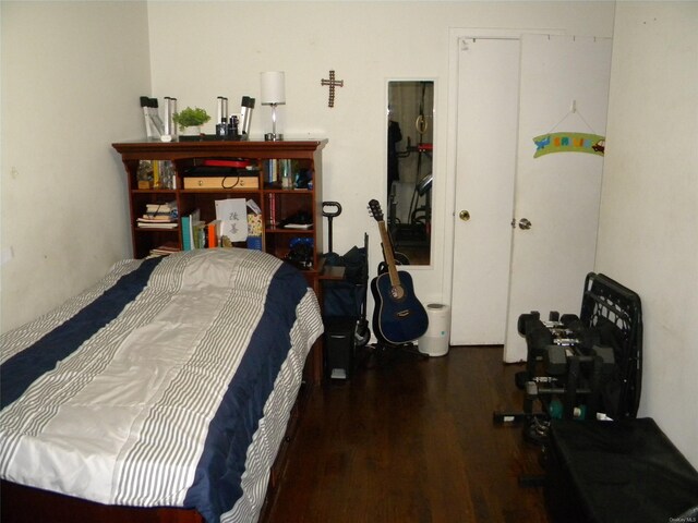 bedroom with dark wood-type flooring