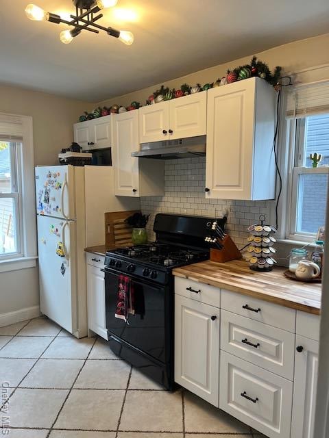 kitchen featuring white cabinets and tasteful backsplash