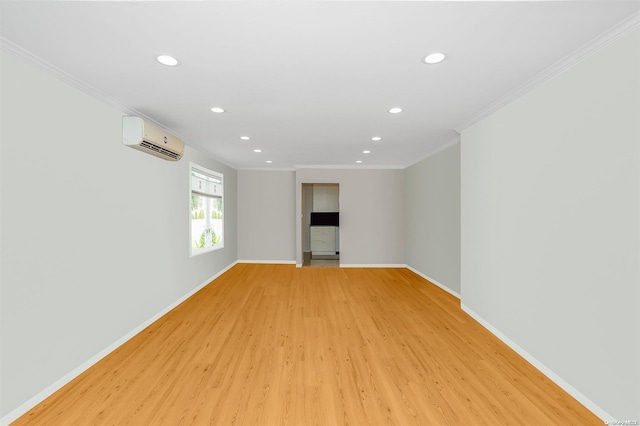 unfurnished room featuring an AC wall unit, light hardwood / wood-style floors, and ornamental molding