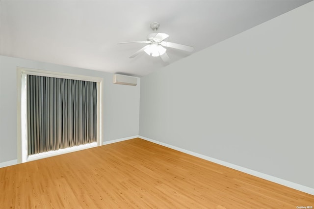 unfurnished room featuring hardwood / wood-style flooring, a wall unit AC, and ceiling fan