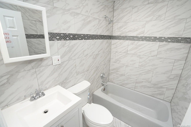 full bathroom with vanity, tiled shower / bath combo, tile walls, and toilet