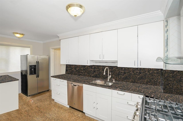 kitchen with dark stone counters, white cabinets, sink, ornamental molding, and appliances with stainless steel finishes