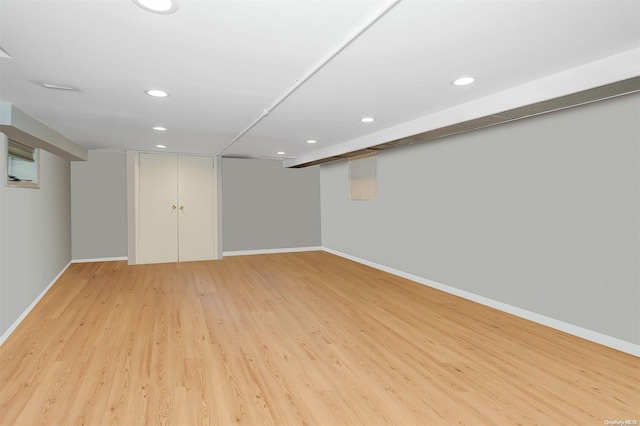 basement with light hardwood / wood-style floors