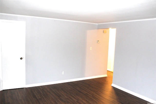 unfurnished room featuring dark hardwood / wood-style flooring and ornamental molding