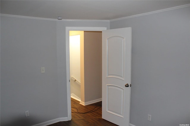 unfurnished room with dark hardwood / wood-style flooring and ornamental molding