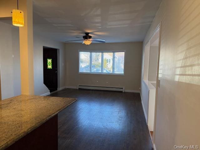 interior space featuring ceiling fan, dark wood-type flooring, and a baseboard radiator