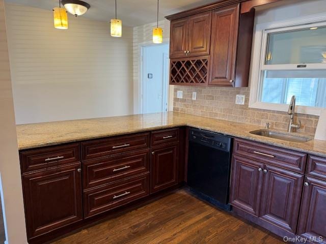 kitchen with tasteful backsplash, dark wood-type flooring, sink, dishwasher, and hanging light fixtures