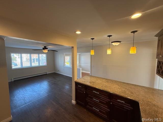 kitchen with dark brown cabinets, baseboard heating, dark wood-type flooring, ceiling fan, and decorative light fixtures