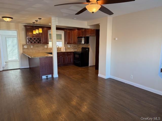 kitchen with black electric range, decorative backsplash, dark hardwood / wood-style flooring, and kitchen peninsula